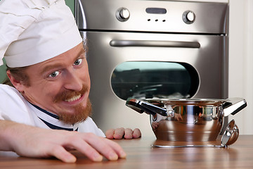 Image showing Funny young chef with a pot