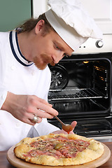 Image showing Young chef prepared italian pizza in kitchen