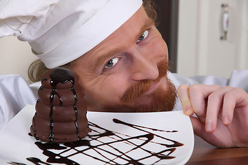 Image showing Young chef with piece of cake