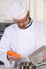 Image showing Young chef preparing lunch in kitchen