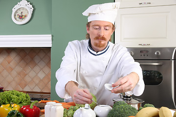 Image showing Young chef preparing lunch in kitchen