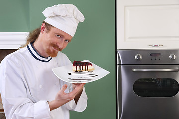 Image showing Young chef with piece of cake