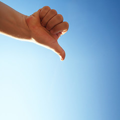 Image showing thumbs down on a blue background