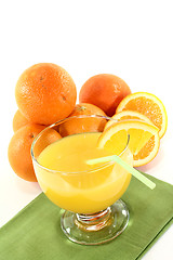 Image showing fresh orange juice with orange halves