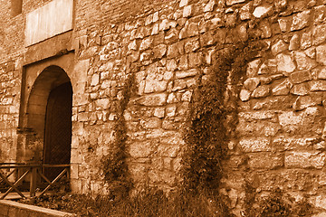 Image showing Medieval stone wall with an iron gate