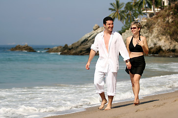 Image showing Young couple walking on the beach