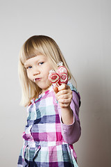 Image showing Little girl with lollipops