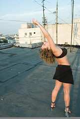 Image showing Young woman on roof