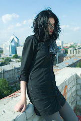 Image showing Young woman on roof