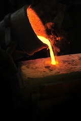 Image showing Foundry - molten metal poured from ladle into mould