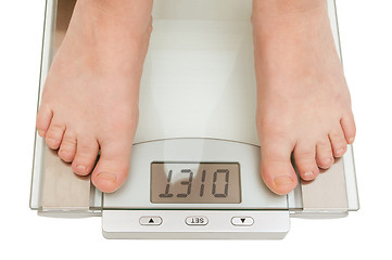 Image showing Female feet on scales