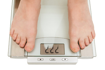 Image showing Female feet on scales