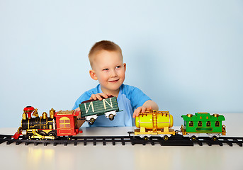 Image showing Boy playing with toy railroad