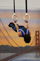 Image showing Gymnast competing on rings