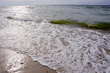 Image showing Sea waves water beating shore sand sun reflection 