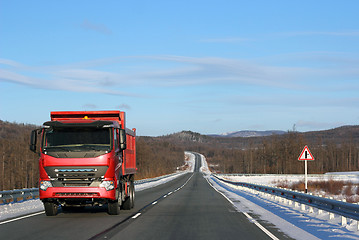 Image showing The red truck on a winter road.