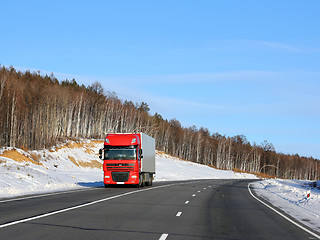 Image showing The red truck on a winter road.