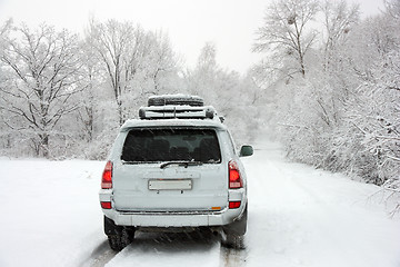 Image showing Snowy winter road behind an unrecognizable car