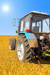Image showing Tractor in a field, agricultural scene in summer