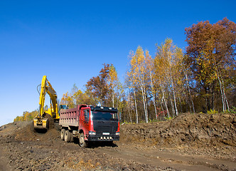 Image showing Yellow backhoe and truck.