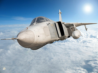 Image showing Military jet bomber Su-24 Fencer flying above the clouds.