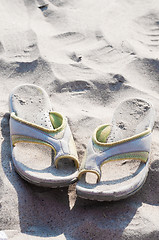 Image showing Flip-flops and sand