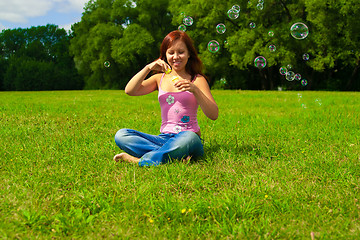 Image showing girl blowing soap bubbles