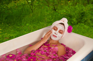 Image showing beautiful woman enjoying floral bath