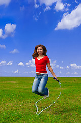Image showing Young woman with skipping rope