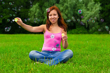 Image showing girl blowing soap bubbles