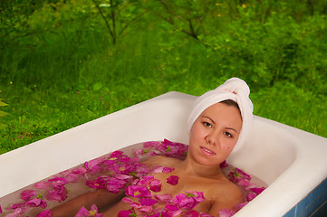 Image showing beautiful woman enjoying floral bath