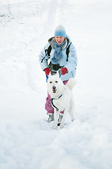 Image showing The woman with a dog in winter on walk