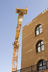 Image showing Construction Crane next to a Building