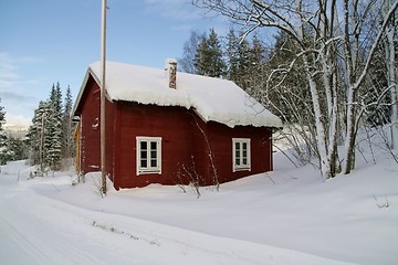 Image showing Red cottage in snow