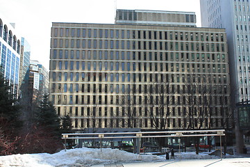 Image showing Building seen from the street with snow in the yard