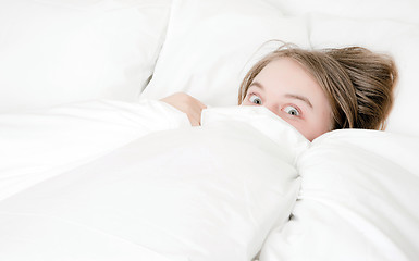 Image showing young woman peeking out