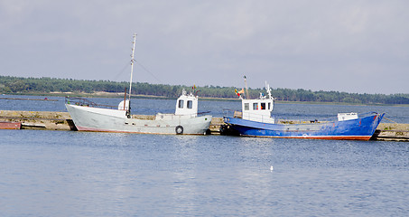 Image showing boats water transport flags rest moored to dock 