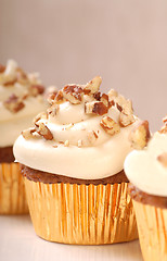 Image showing Delicious carrot cake cupcake with cream cheese frosting and nut