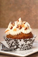 Image showing Delicious carrot cake cupcake with cream cheese frosting and nut
