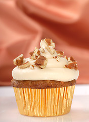 Image showing Delicious carrot cake cupcake with cream cheese frosting and nut