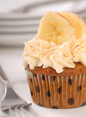 Image showing Delicious carrot cake cupcake with cream cheese frosting, sliced