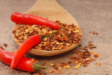 Image showing Red chili peppers and red pepper flakes on a spoon