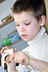 Image showing childr shaping clay in pottery studio