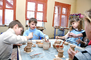 Image showing children shaping clay in pottery studio