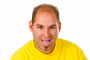 Image showing Young man put out his tongue