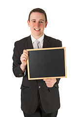 Image showing Businessman holding a black board