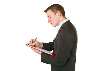 Image showing Businessman writing on a clipboard