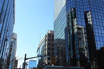 Image showing Buildings,flag and clear sky reflected on blue glass of a building, Queen St. 