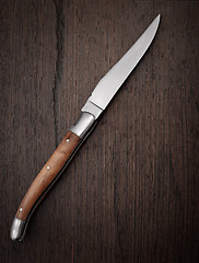 Image showing Knife on wooden background