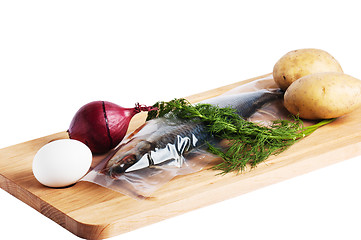 Image showing Vegetables and a salty herring on a kitchen board